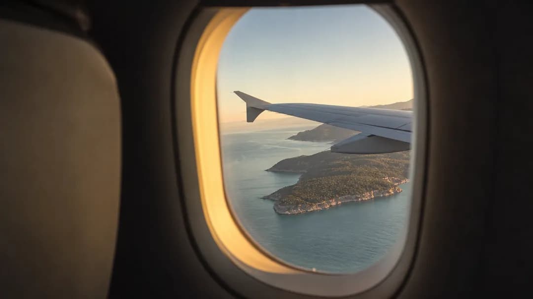 The view over the Mediterranean coast from an aircraft window at golden hour