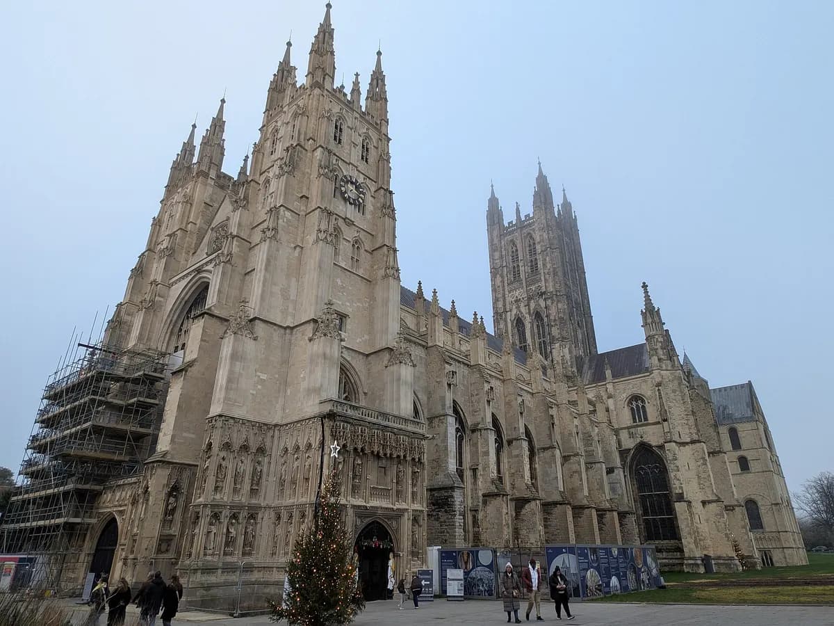 Canterbury: a great cathedral tower rising above medieval streets and a river punt