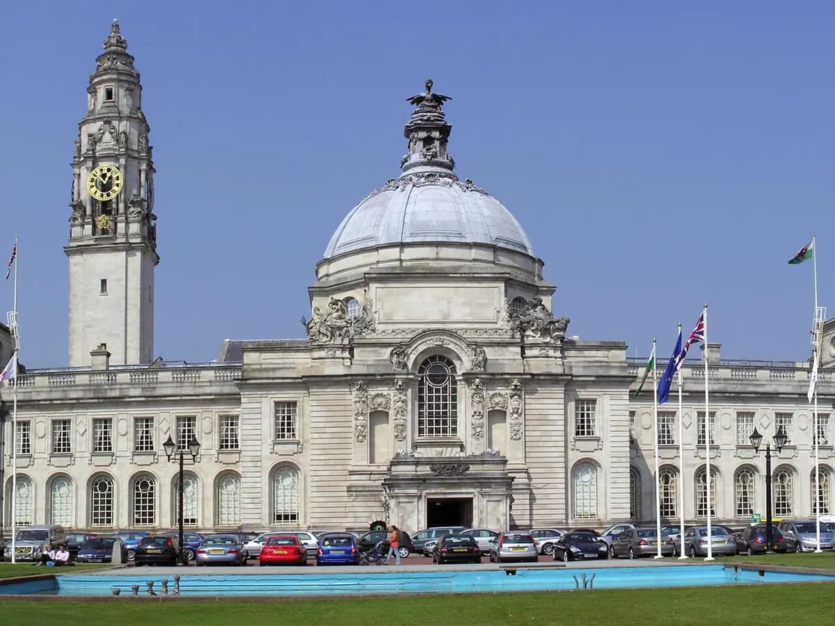 Cardiff: a castle wall carved with animals, a white Portland-stone domed civic building, a bay barrage beyond