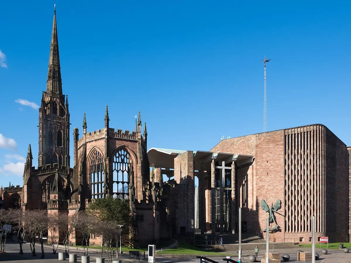 Coventry: a modern cathedral standing beside the roofless ruins of a bombed medieval one