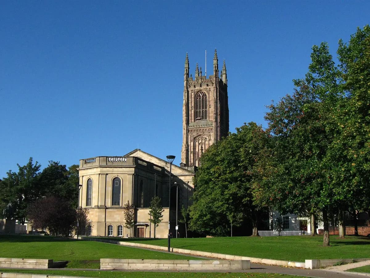 Derby: a tall cathedral tower and a red-brick silk mill beside the river