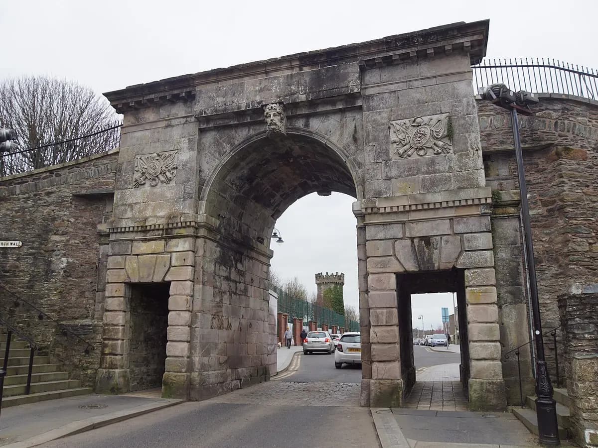 Derry: seventeenth-century city walls above a river crossed by a curving pedestrian bridge