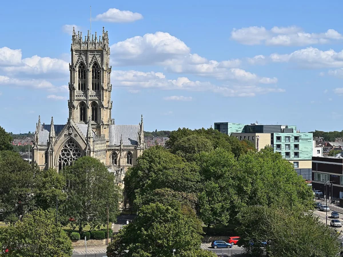 Doncaster: a racecourse grandstand and a minster church tower across the flat fields