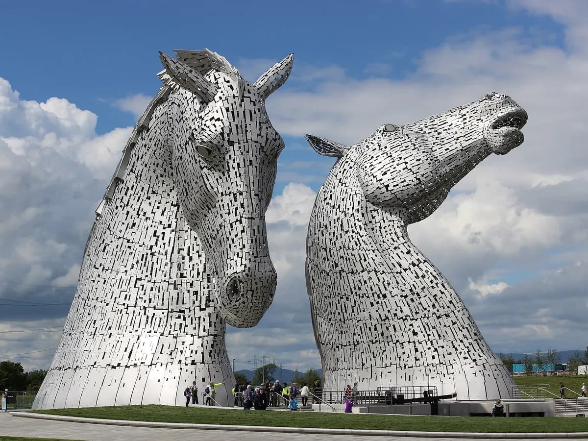 Falkirk: a rotating boat-lift wheel on a canal and two enormous horse-head sculptures beyond