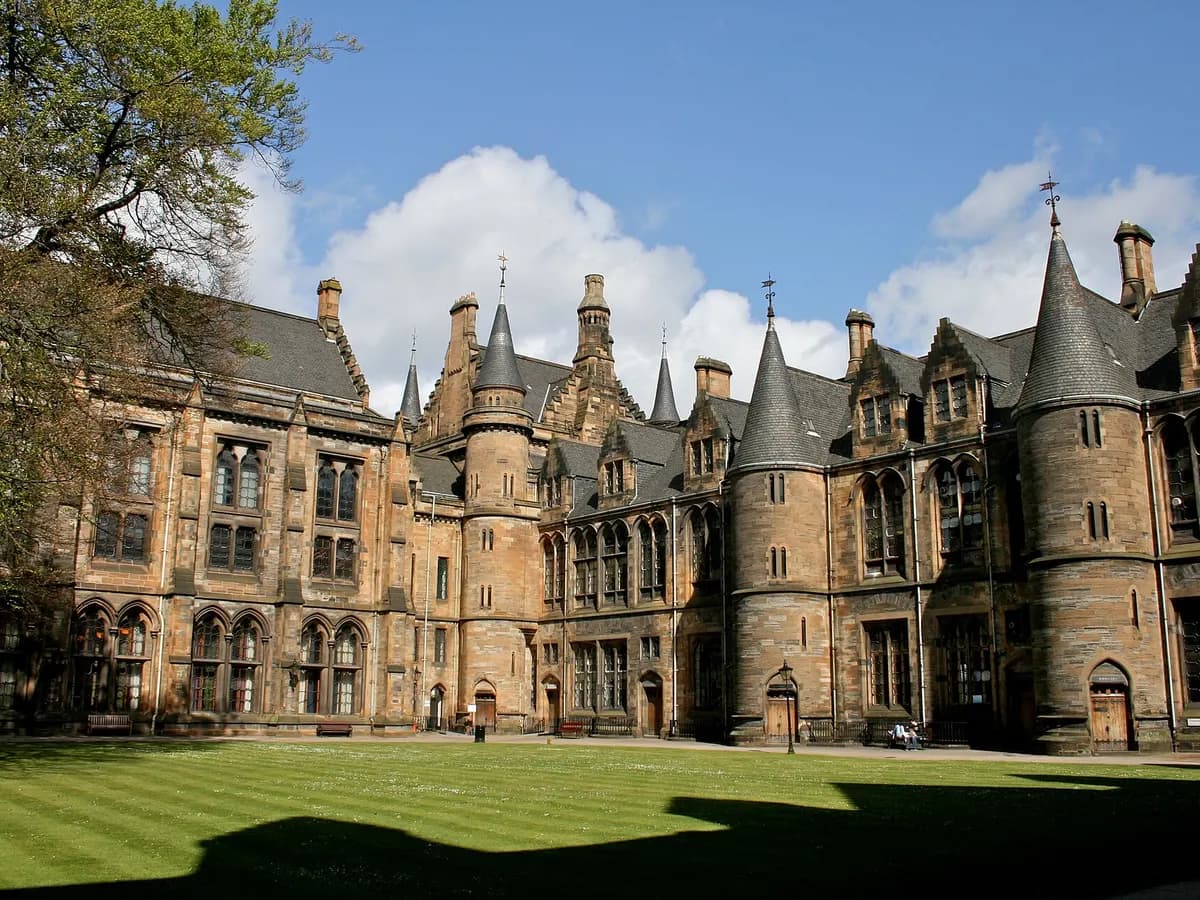 Glasgow: red sandstone tenements below a Victorian university tower, a titanium-clad riverside building