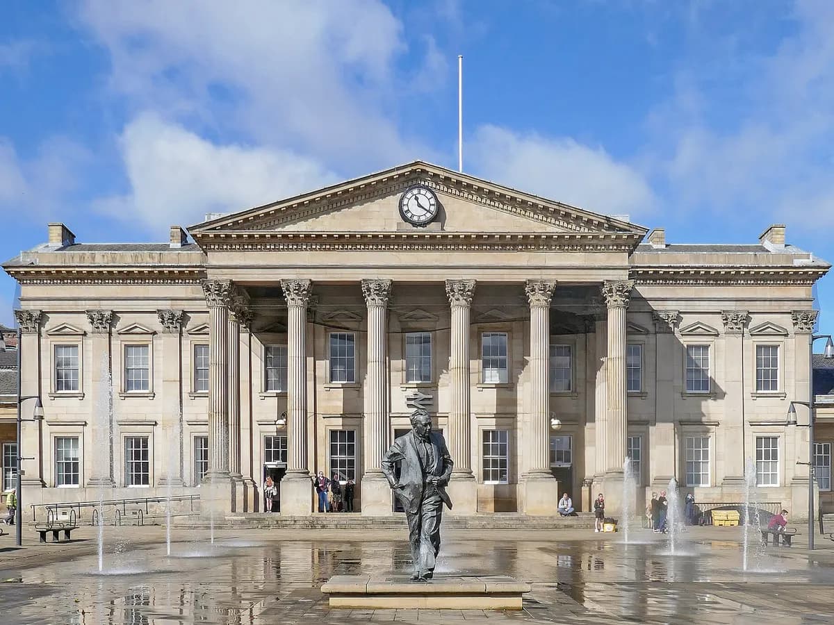 Huddersfield: a long classical railway station facade with a colonnade of columns