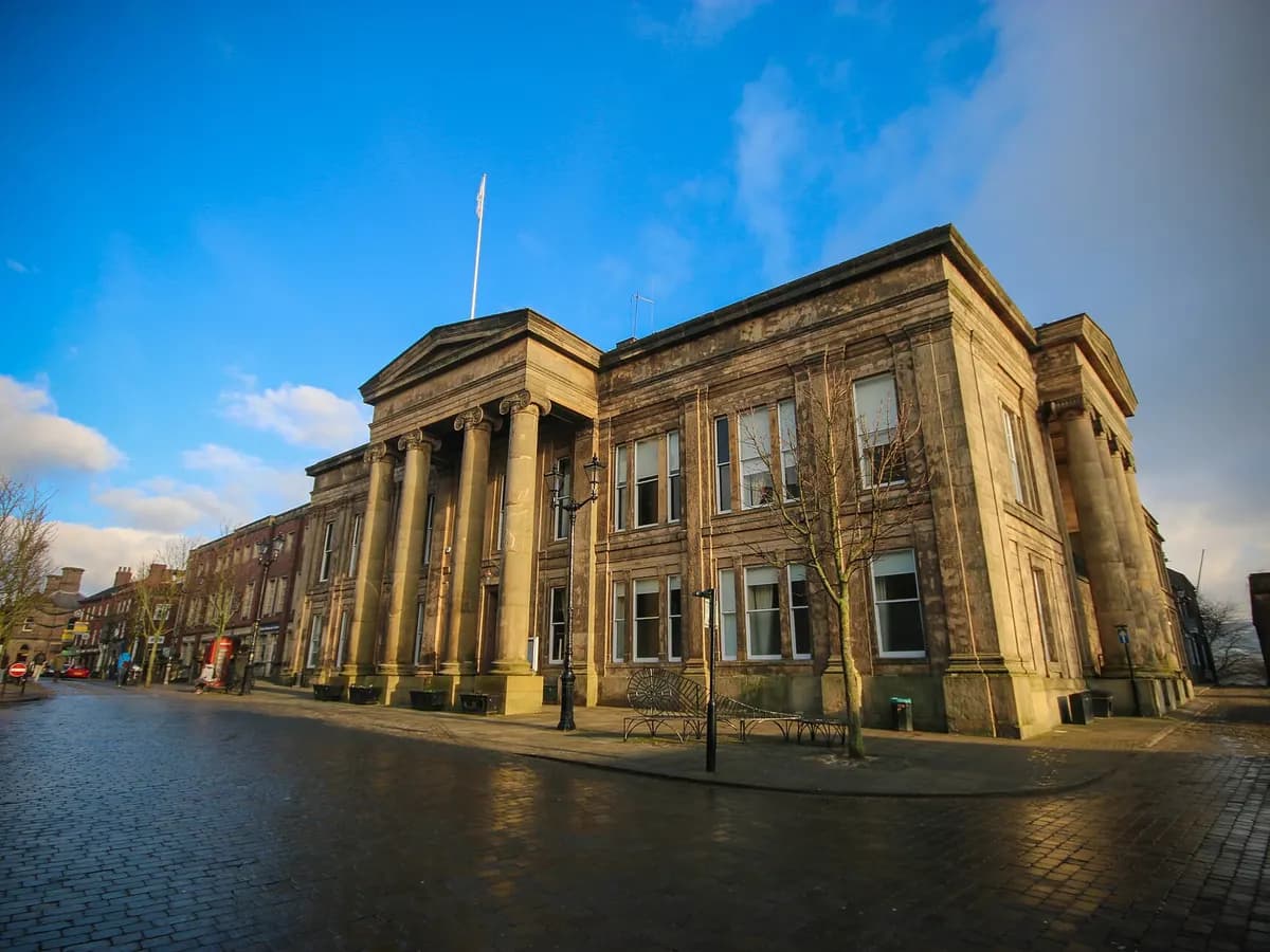Macclesfield: stone silk mills on a hillside town with the Peak District moors behind