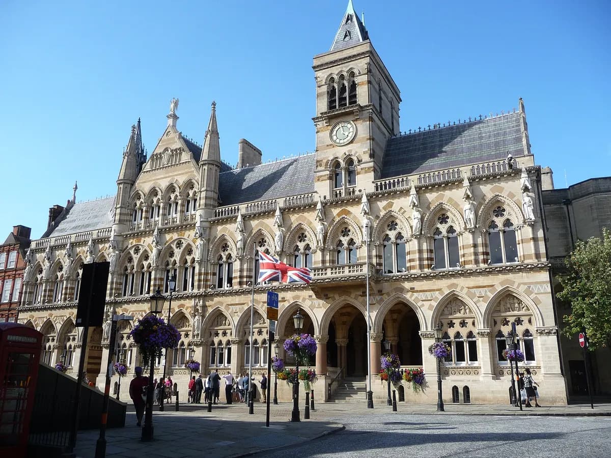 Northampton: a tall slender concrete lift-testing tower above a market square