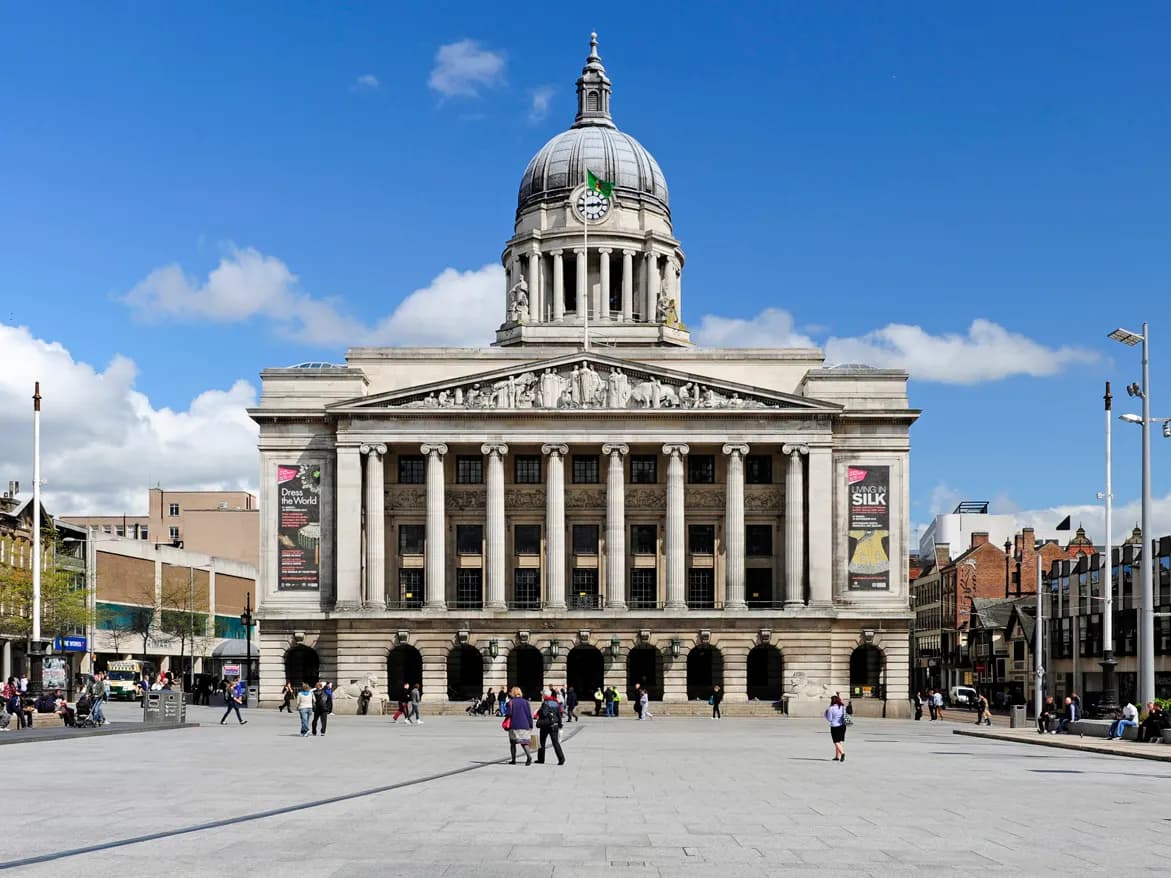Nottingham: a castle on a sandstone rock riddled with caves, a domed council house below