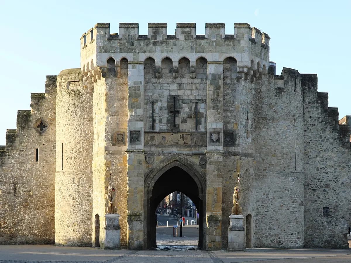 Southampton: a cruise liner at a dock behind a stretch of medieval town wall