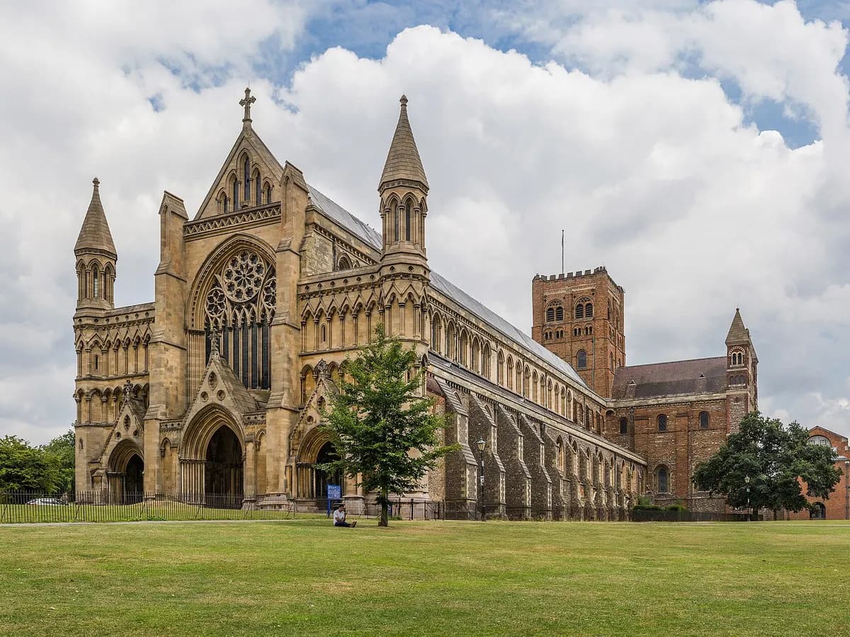 St Albans: a long Norman abbey with a flint-and-Roman-brick tower on a hill above a lake