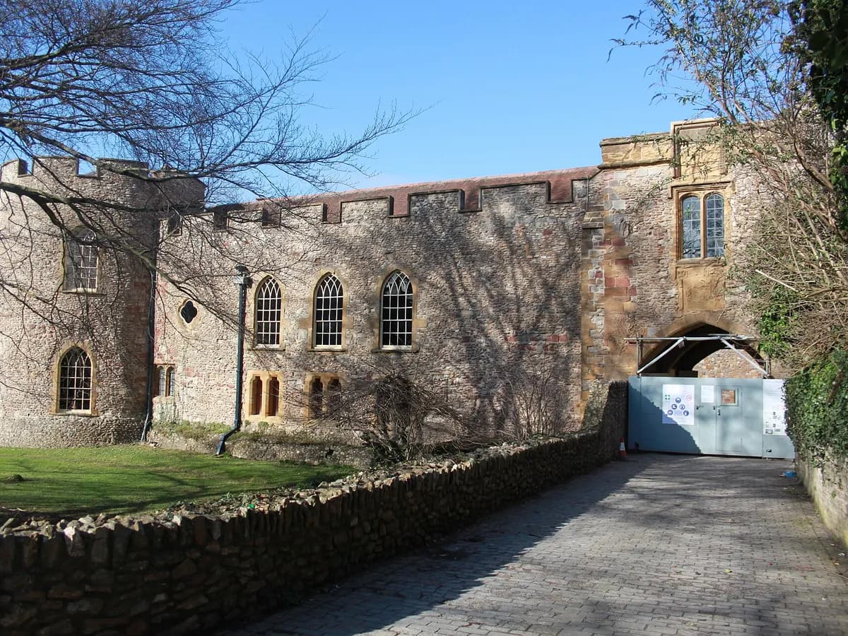 Taunton: a red sandstone castle gatehouse and a cricket ground in a green vale
