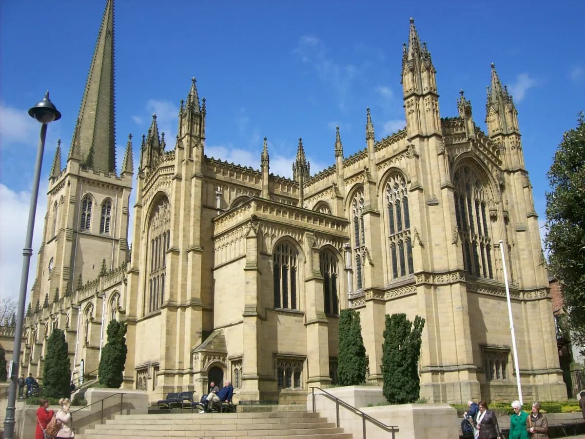 Wakefield: a tall cathedral spire and a small chantry chapel standing on a bridge