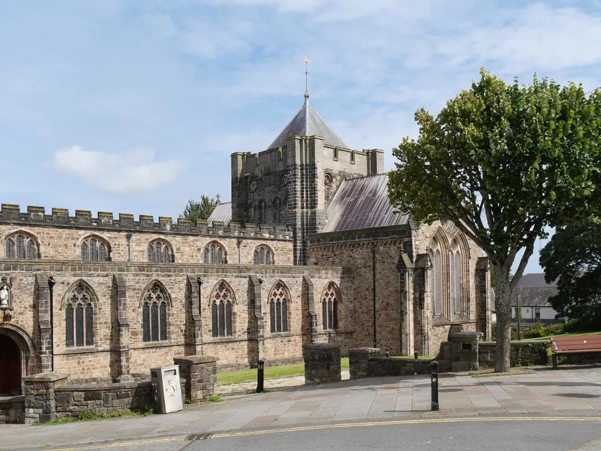 Bangor, Wales: a small cathedral city on a strait with a long wooden pier and mountains behind