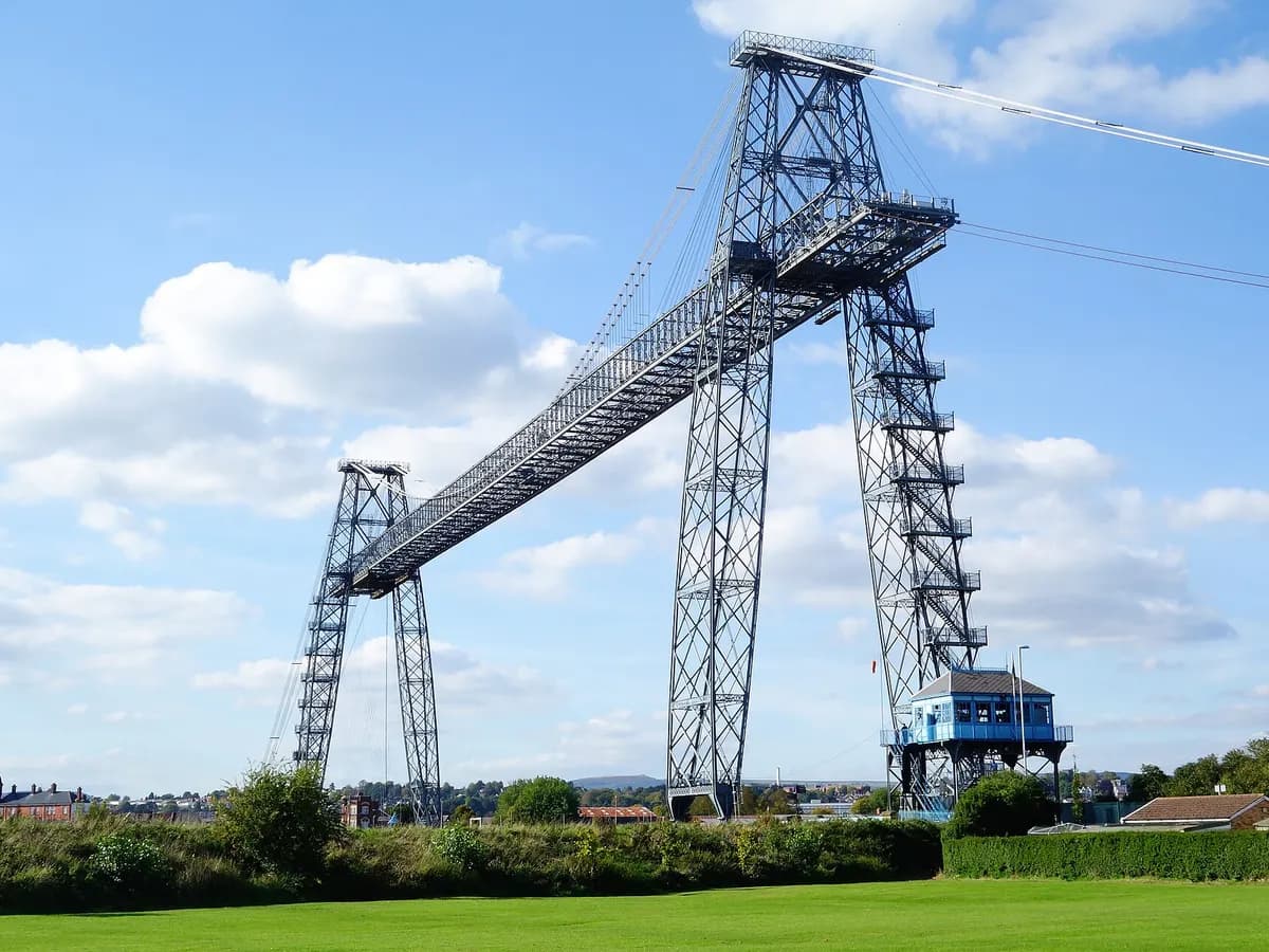 Newport, Wales: a transporter bridge with a high blue lattice span carrying a gondola over the river