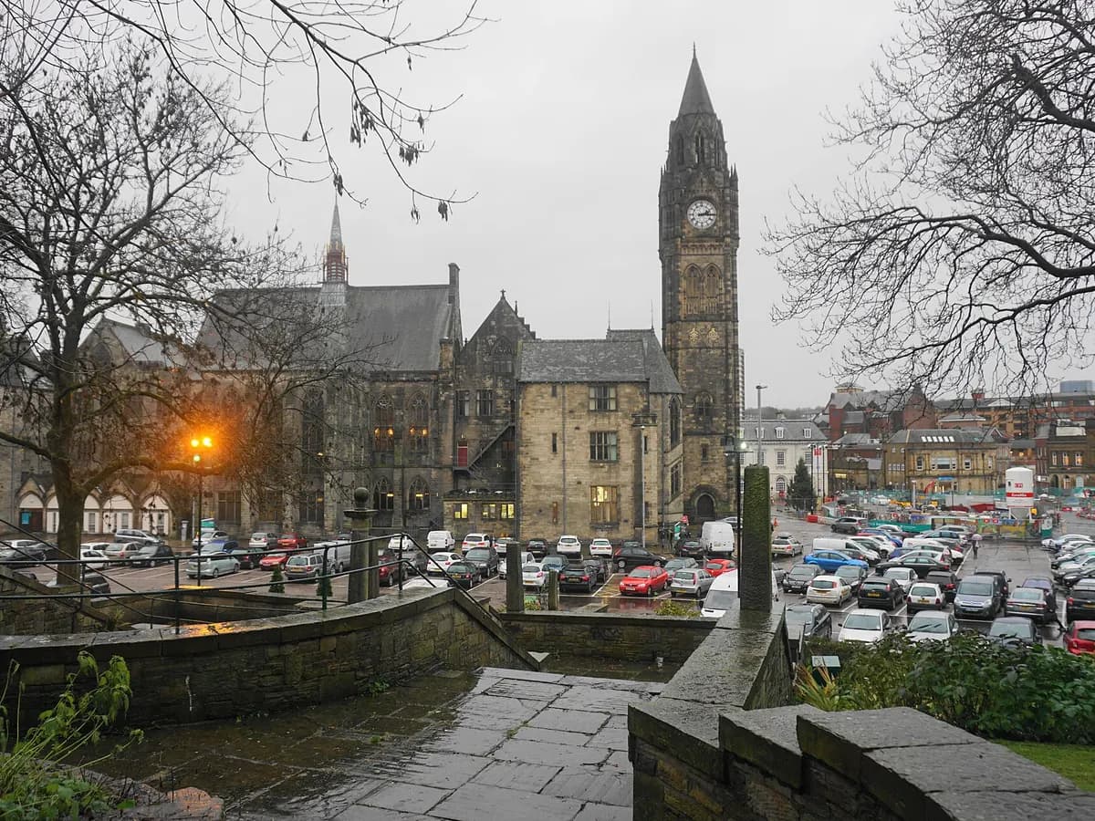 Rochdale: a grand Gothic town hall with a tall spire beside a river