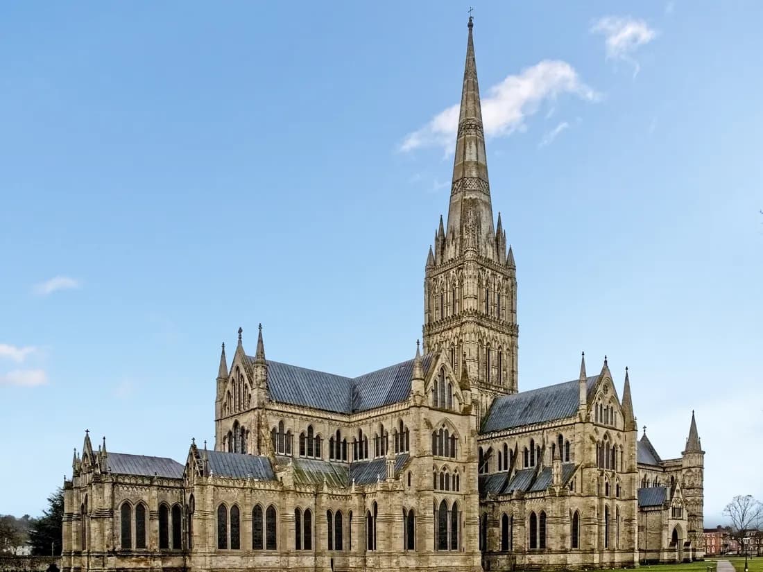 Salisbury: an extremely tall cathedral spire above green water meadows and a river